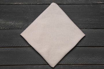 Folded napkin on dark wooden background
