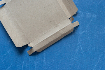 deconstructed cardboard box on blue scrapbook paper with texture