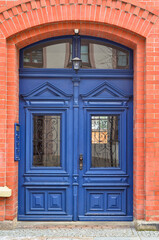 View of brick building with blue wooden door