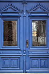 View of blue wooden door in city