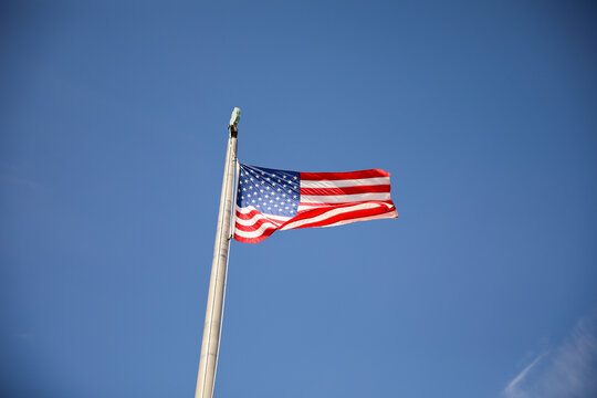 US flag depicting historic freedom and american pride along with independence of fourth of july and patriotism on a national level in the sky and home