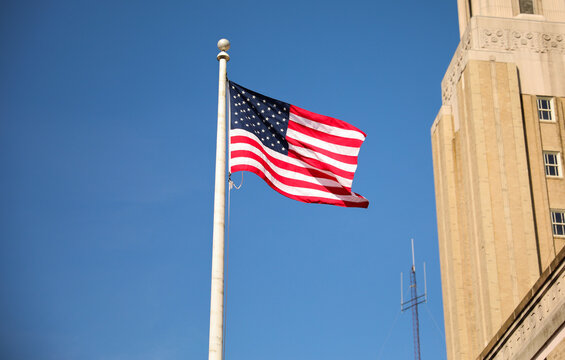 US flag depicting historic freedom and american pride along with independence of fourth of july and patriotism on a national level in the sky and home