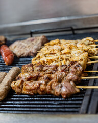 Greek traditional grilled souvlaki on a barbeque fire selective focus.