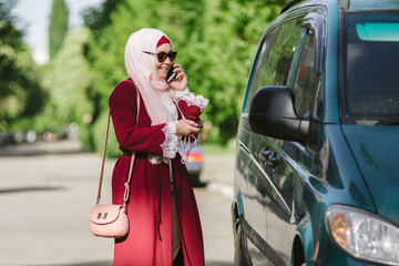 pretty muslim woman use a cellphone at park
