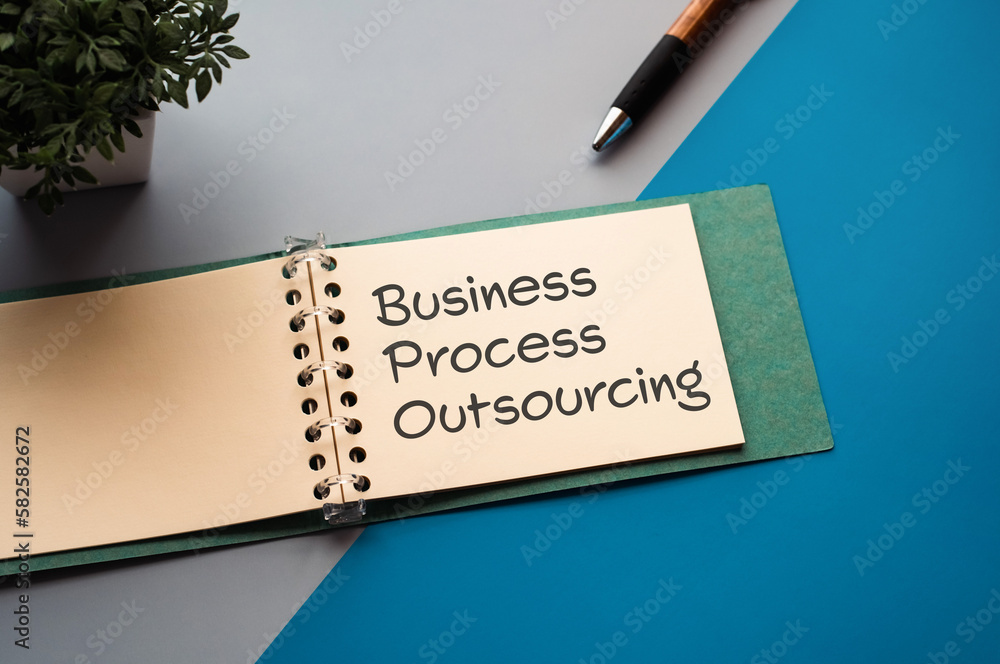 Poster there is a notebook with the word business process outsourcing. it is eye-catching image.