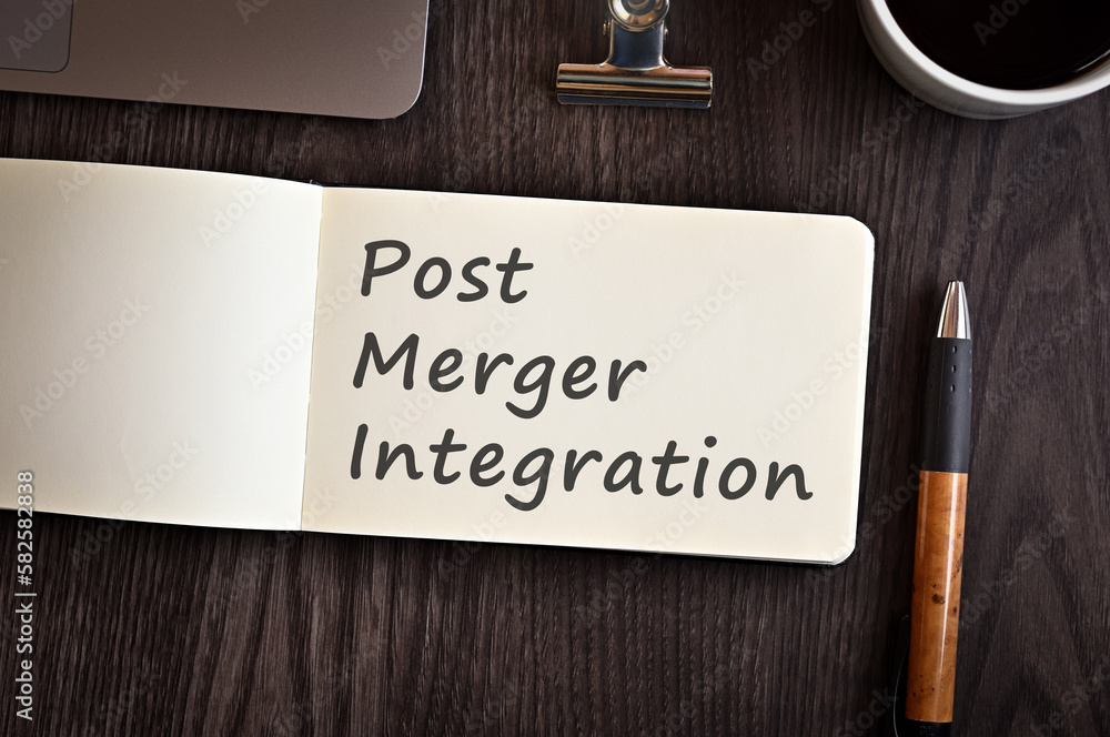 Poster there is a notebook with the word post merger integration. it is eye-catching image.