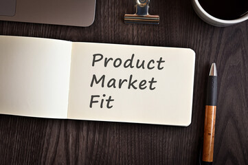 There is a notebook with the word Product Market Fit. It is eye-catching image.