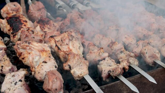 Cooking shish kebabs on coals. Traditional Armenian shish kebab. 4K video