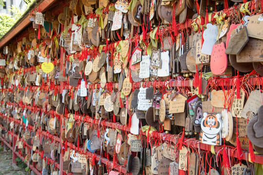 Wooden plaques written with wishes hang on racks at Hinoki Village Chiayi
