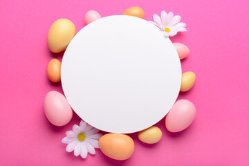 Blank card with Easter eggs and flowers on pink background