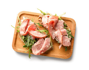 Wooden board of tasty bruschettas with ham isolated on white background