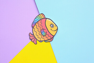 Paper fish on color background. April Fools' Day celebration