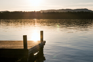 Jetty on a lake with evening sun