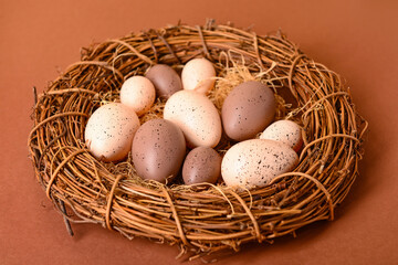 Wreath with Easter eggs on brown background