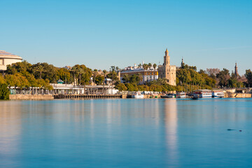 Long exposure of Guadalquivir River from Triana with the Torre del Oro, the govenments building