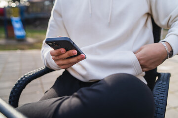 Close up of man hands using phone for texting
