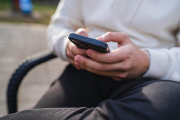Close up of man hands using phone for texting