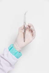 Hands holding forceps for procedure in surgery