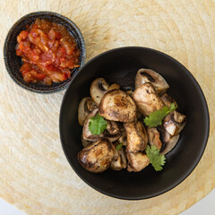 Grilled Mushrooms with tomato sauce on a plate.