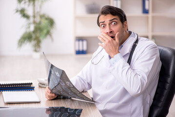 Young male doctor radiologist working in the clinic