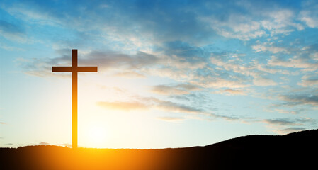 Christian cross on hill outdoors at sunrise. Resurrection of Jesus. Concept photo.