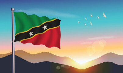 ST. Kitts Nevis flag with mountains and morning sun in background