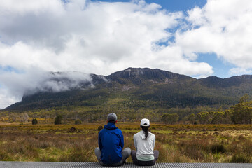 A pair of traveller couple watching  the peak of Mount Oakleigh in the Overland Track, Cradle...