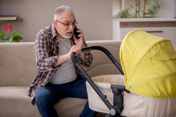 Old man looking after newborn at home