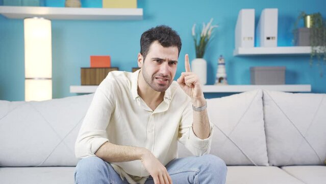 Young man with anxiety disorder in a thoughtful state.
Stressed and angry young man is thinking, his worries are bothering him.
