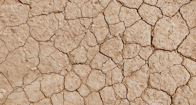 Cracked ground background in the top view for graphic design or wallpaper