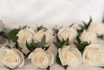 Obraz na płótnie Canvas White Rose Wedding Boutonnieres on White Background
