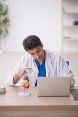 Young male doctor cardiologist working in the clinic