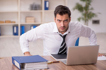 Young male employee working in the office