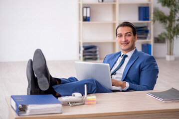 Young male employee working in the office
