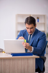 Young male employee working in the office
