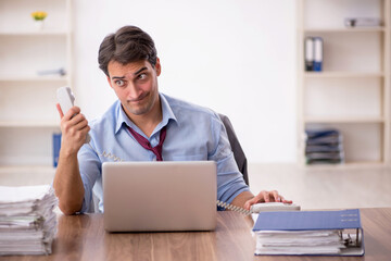 Young male employee working in the office