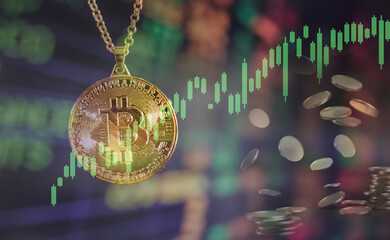 Bitcoin gold coin and defocused chart background.