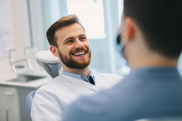 Smiling male dentist with a stethoscope around his neck, talking to a patient and putting them at ease before a dental procedure, generative ai