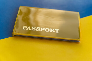 Flag of ukraine with passport. Travel visa and citizenship concept. residence permit in the country. a yellow document with the inscription passport is on flag. Close up, top view