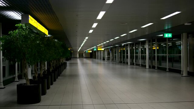 Schiphol Airport, Netherlands 2023 Empty moving sidewalk or walkway in Schiphol Amsterdam airport terminal due to coronavirus pandemic lockdown no people but very clean surfaces and silence