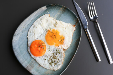 Fried eggs in the plate close up ,