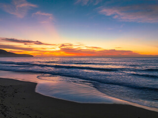 Fototapeta na wymiar Sunrise at the seaside with pretty clouds