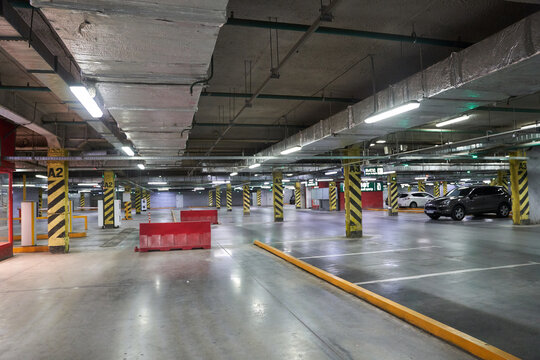 Selective focus of underground parking in a shopping mall. Parking restrictions. With a space to copy. Navigation in the parking lot. Free parking space. High quality photo