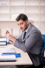 Young male employee working in the office