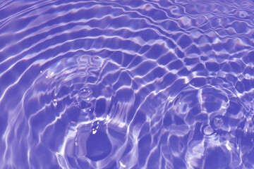 Defocus blurred transparent purple colored clear calm water surface texture with splash, bubble....