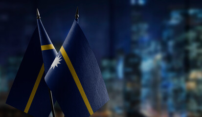 Small flags of the Nauru on an abstract blurry background