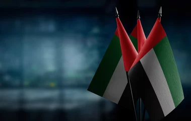 Foto op Canvas Small flags of the Arab Emirates on an abstract blurry background © butenkow