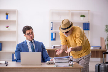 Fototapeta premium Old male boss and young male employee in summer vacation concept