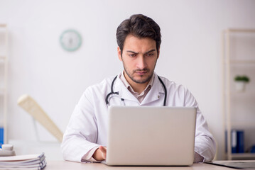 Young male doctor in telemedicine concept