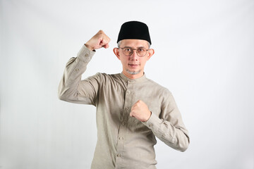 Fototapeta premium Portrait of Asian Moslem Man with a spirited expression ,celebrating success isolated over white background. 